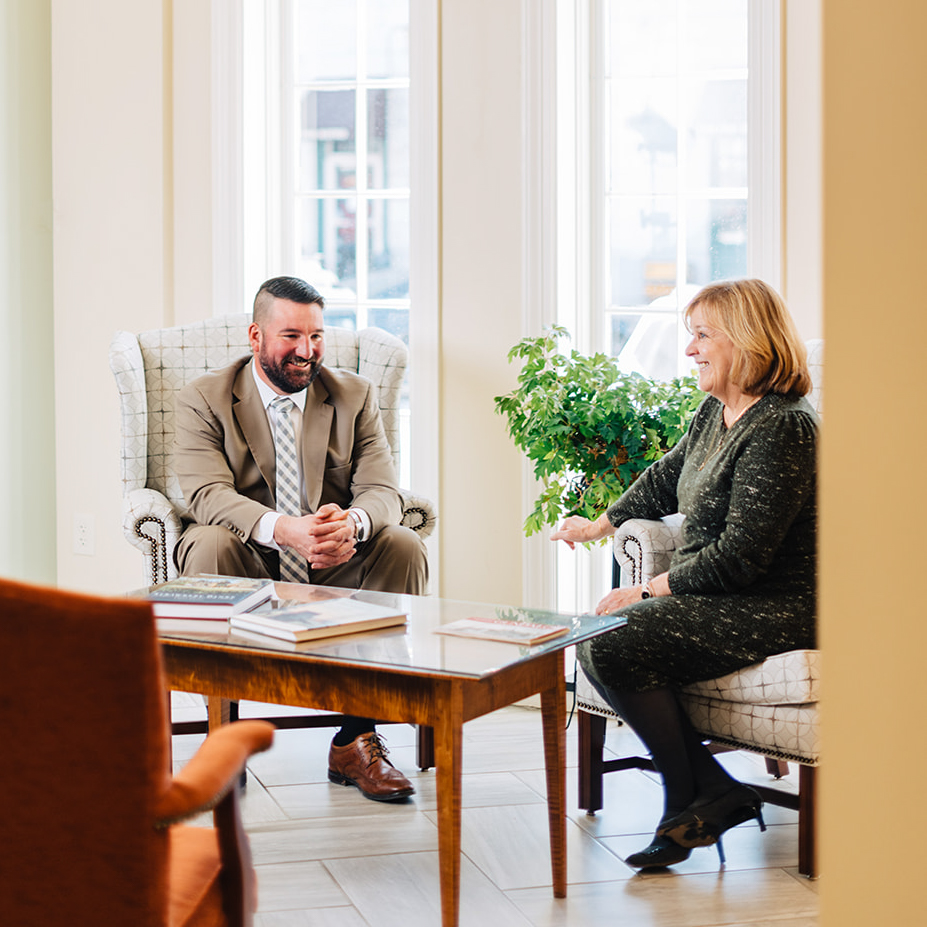 A man and woman sitting down having a conversation