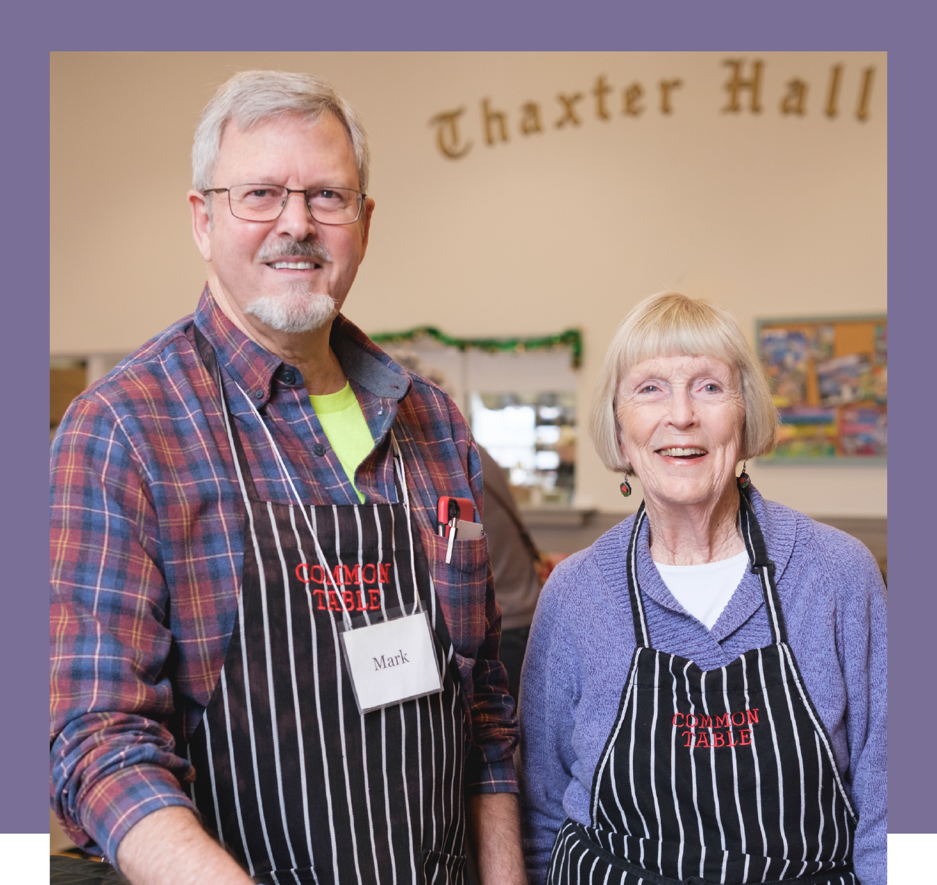 img-here-for-good-campaign-customer-testimonial-st-johns-common-table a photo of a man and woman wearing striped aprons in front of a sign that says Thaxter Hall